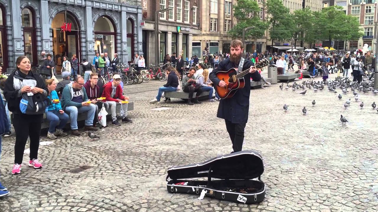 Street musician Singing Bob Marley no woman no cry in Amsterdam