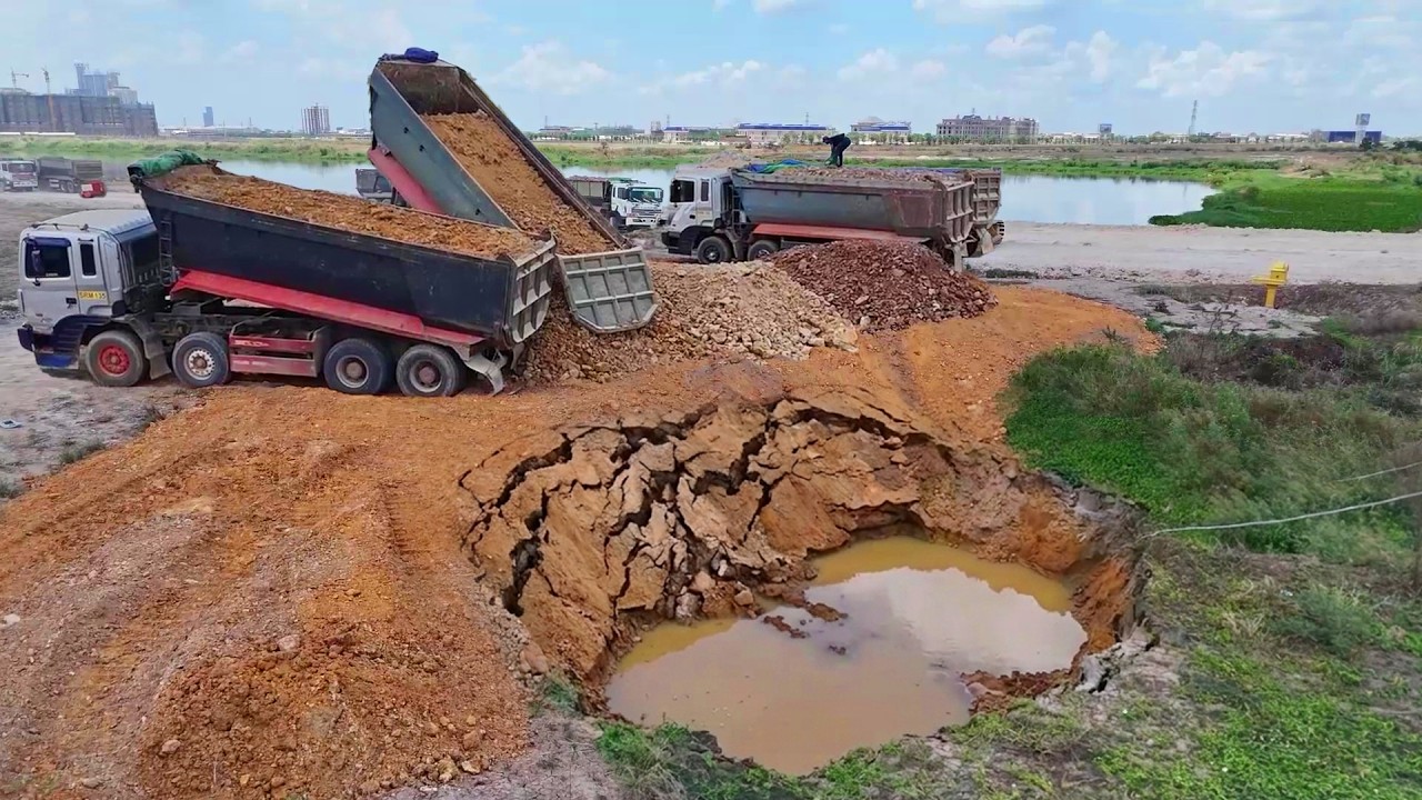 Complete Great work !! Heavy dump truck wheel 10 unloading soil landfilling flooded area & Bulldozer