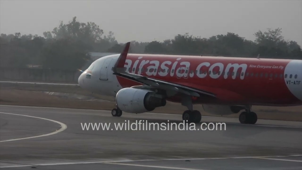 Air Asia airplane takes off after heavy winter rain shower at Delhi airport T3