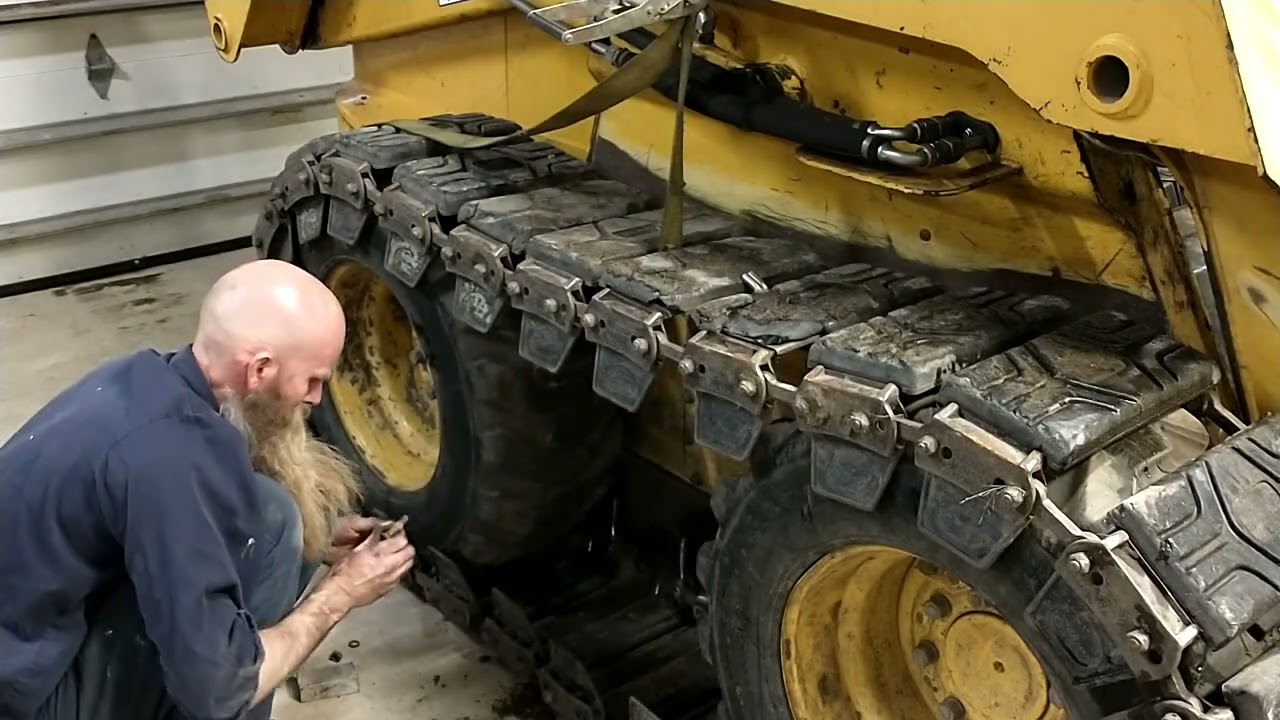 The easy way to adjust McLaren skid steer tracks on a John Deere 280