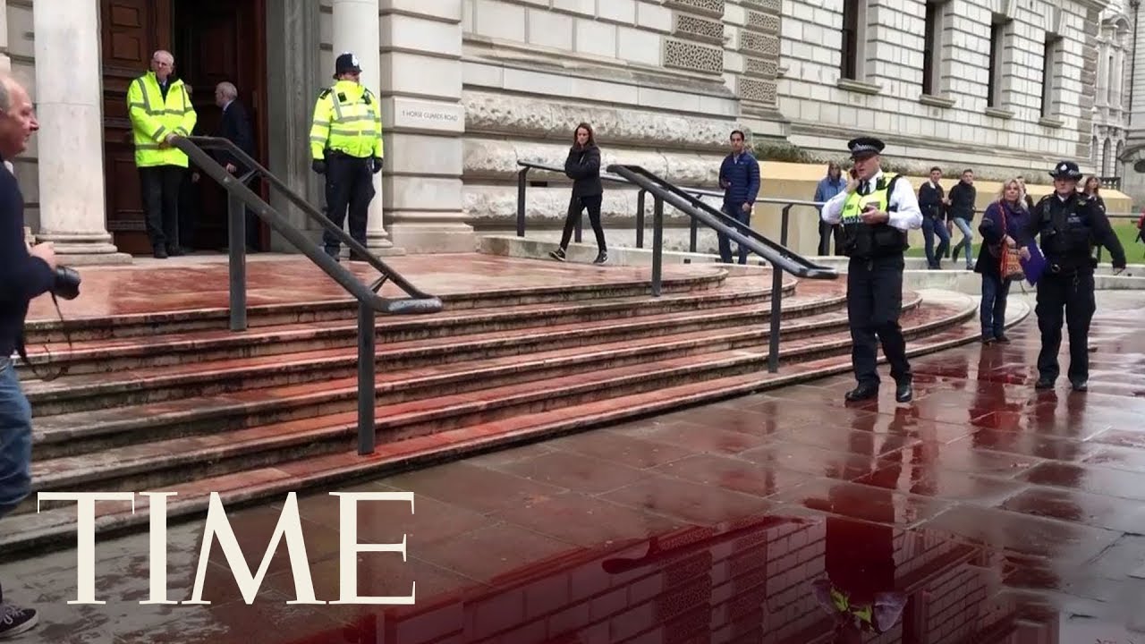 Climate Change Activists Spray Fake Blood Over U.K. Government Building | TIME