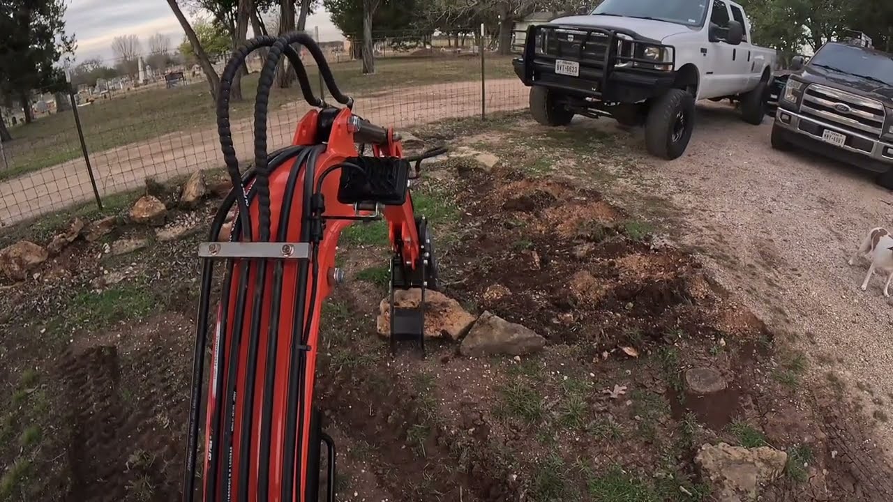 Moving rocks with mini Chinese excavator QH12 and digging up a stump