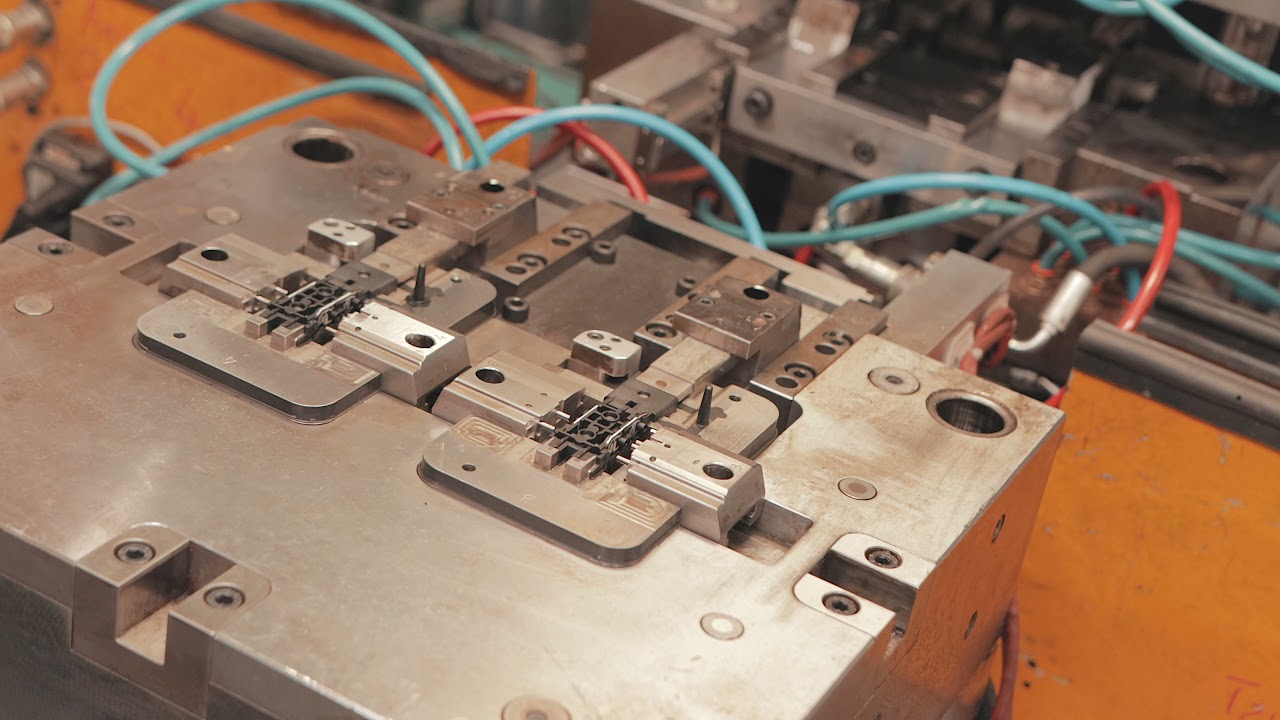 Insert moulding of a lead frame with integrated connector