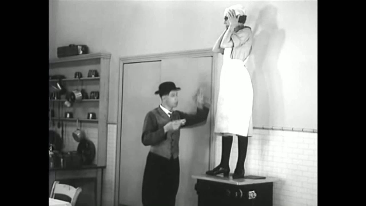 (1934) Beryl Formby dancing on a cooking facility while George playing a mouthharp