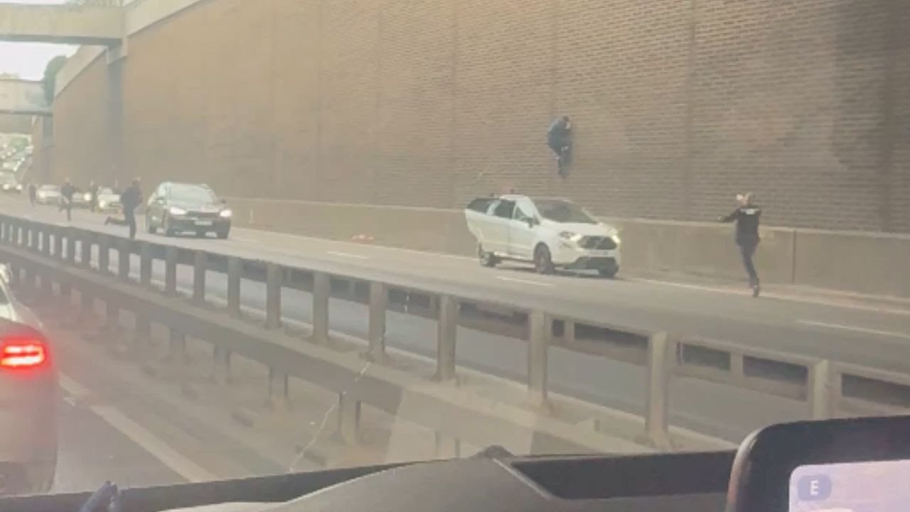 Wall Climber Chase: Police Surround Man on A406 in Tense Standoff || WooGlobe