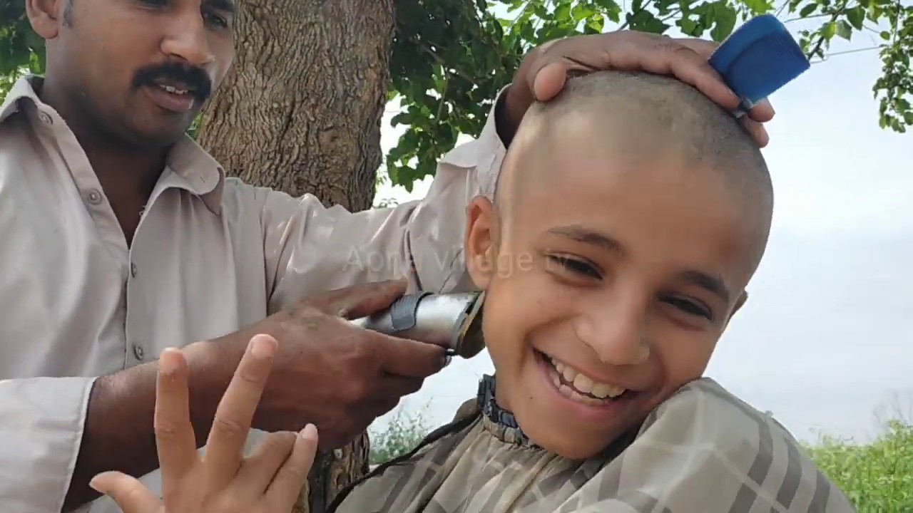 barber clipper head shave haircut village boy in Punjab pakistan