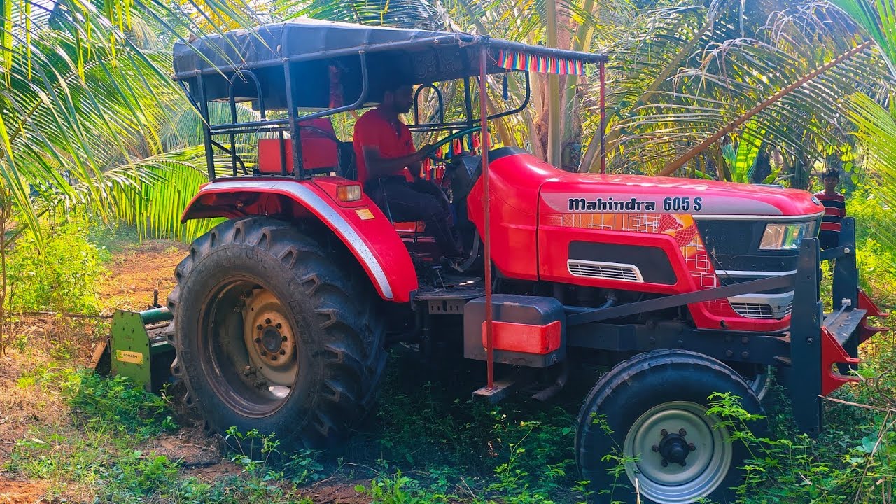 Mahindra arjun novo 605 di tractor goes to rotavator performance in coconut tree land 