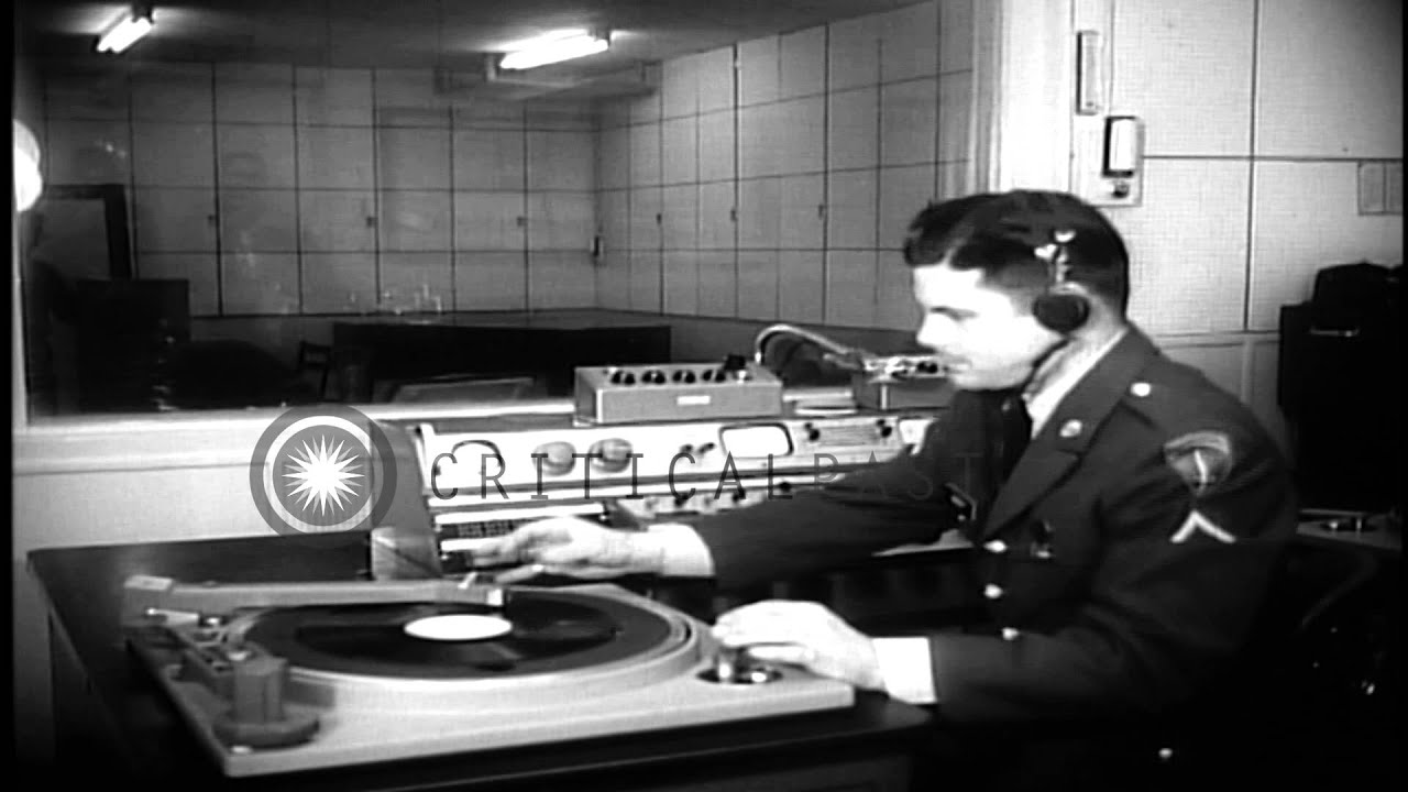 Disc Jockey selects and plays record at AFN (American Forces Network) studio in B...HD Stock Footage