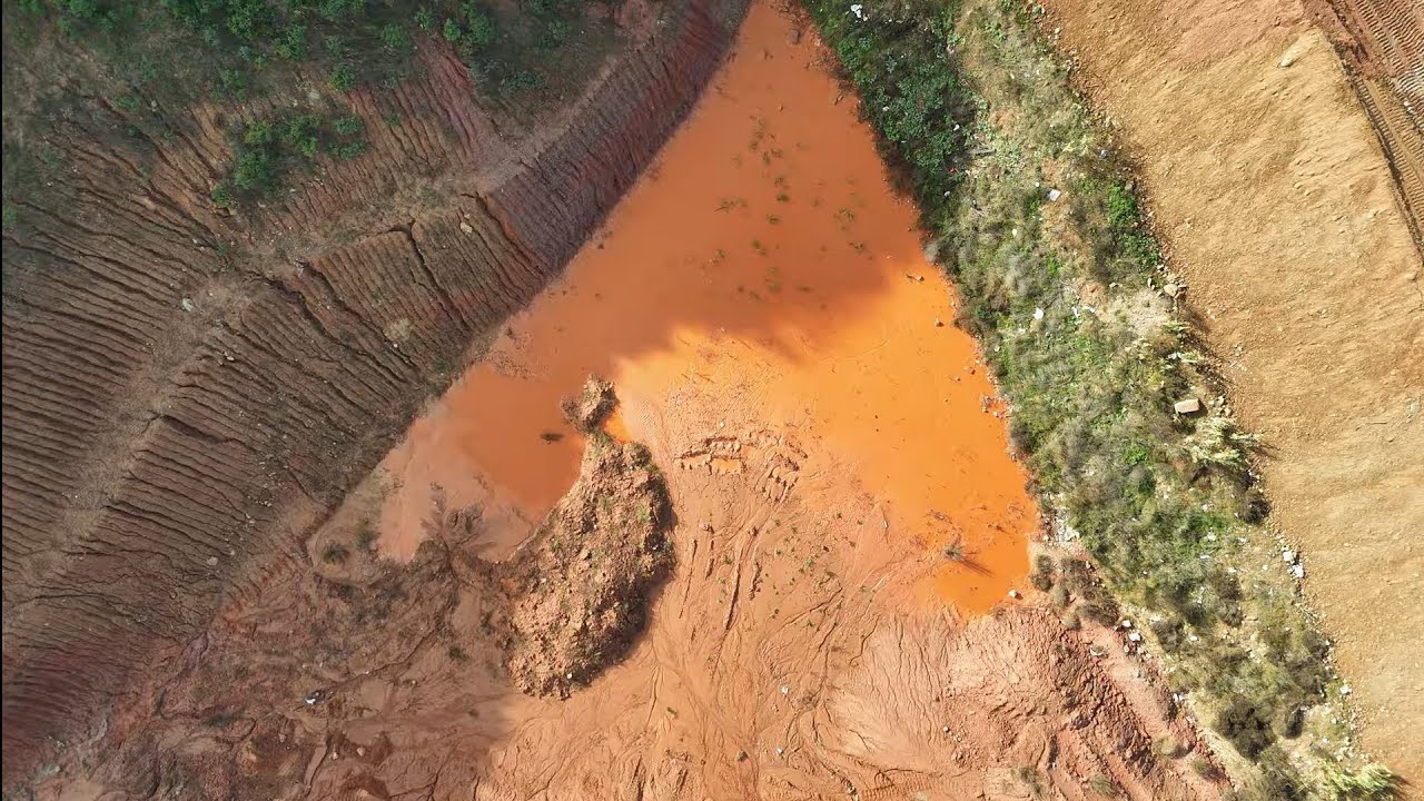 Large quarry in Spain. Drone footage flying over interesting red terrain.