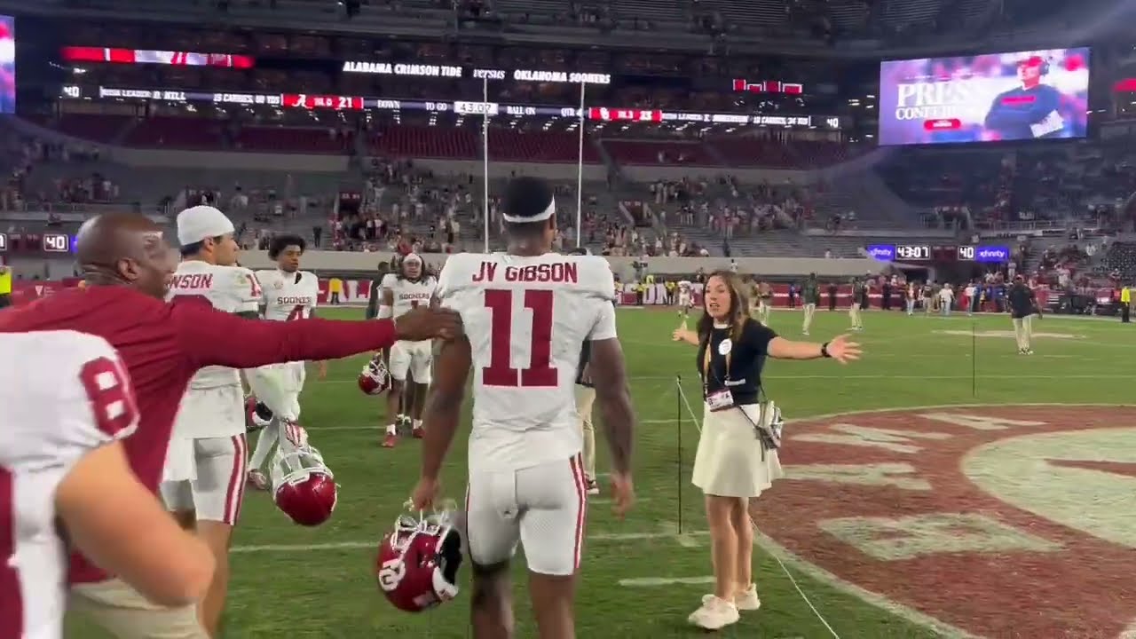 Alabama staffer not happy as Oklahoma players take photos on midfield logo after beating Tide