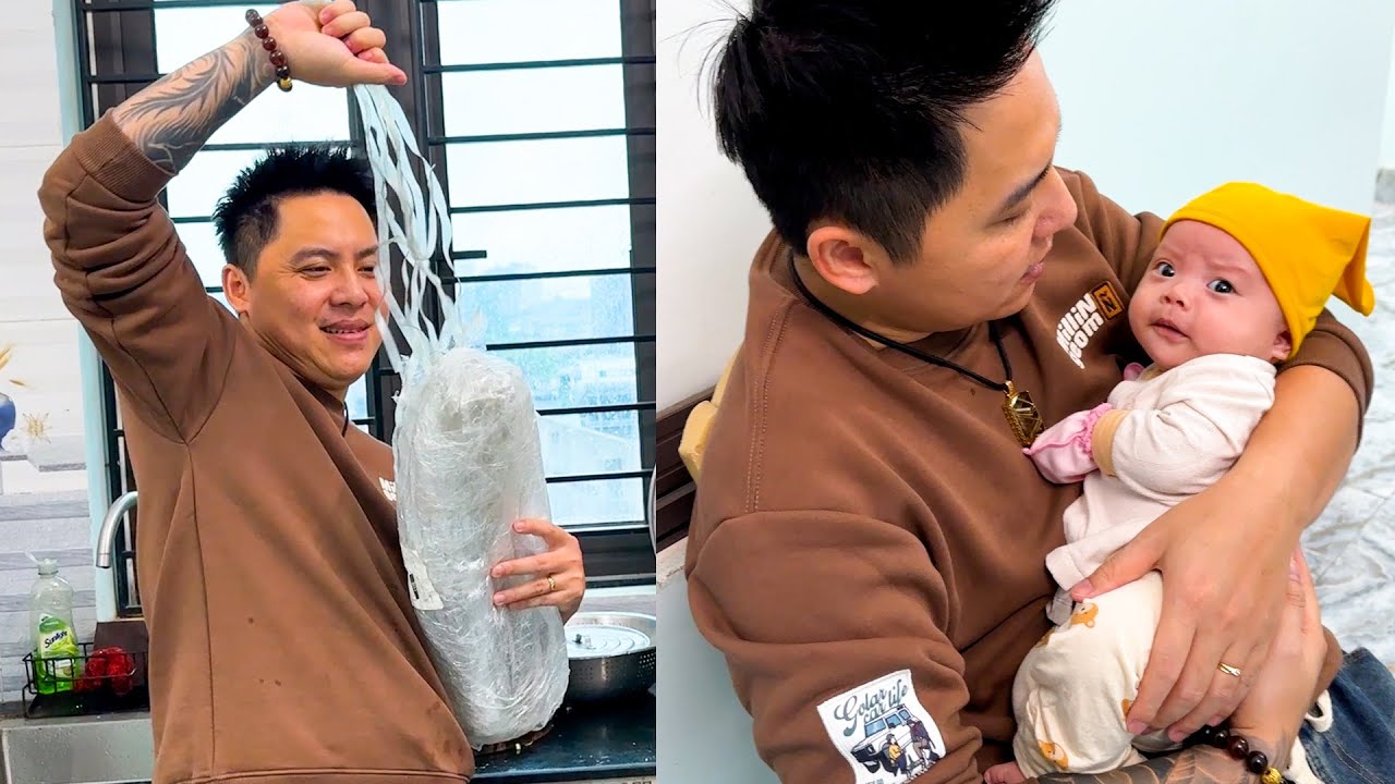 The capable dad manages to cook while holding baby Banh Bao