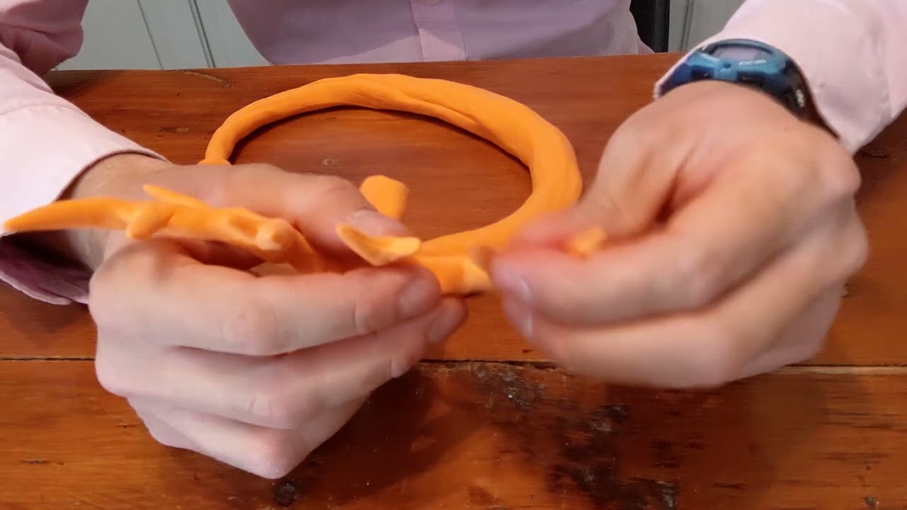 Making a statue sculpture out of orange colored clay 11