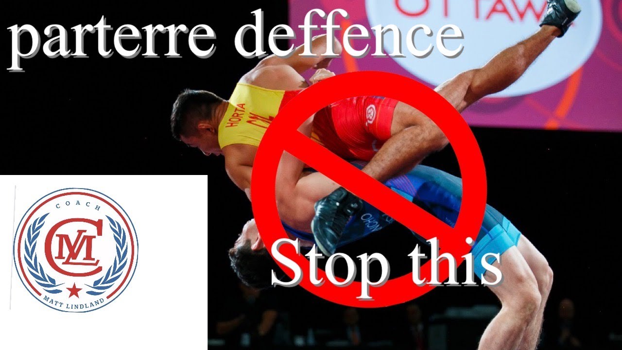 Defending scores in parterre position Greco-Roman wrestling