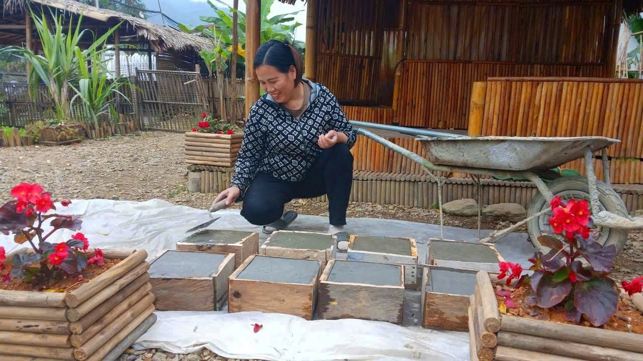 DAN happily cast concrete blocks to serve as pillars for his new house.