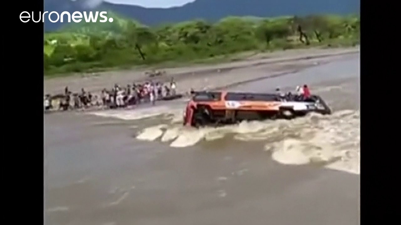 Passengers escape through windows as bus overturns in swollen river, Peru