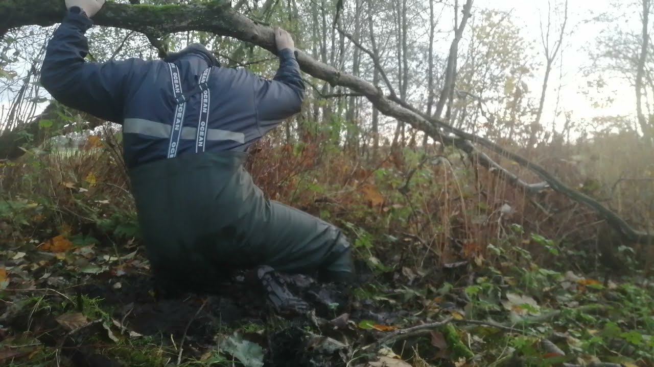 Chest waders in knee deep mud.