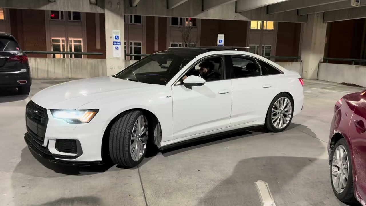 My 2019 Audi A6 3.0t with downpipes and straight pipe exhuast in a parking garage.