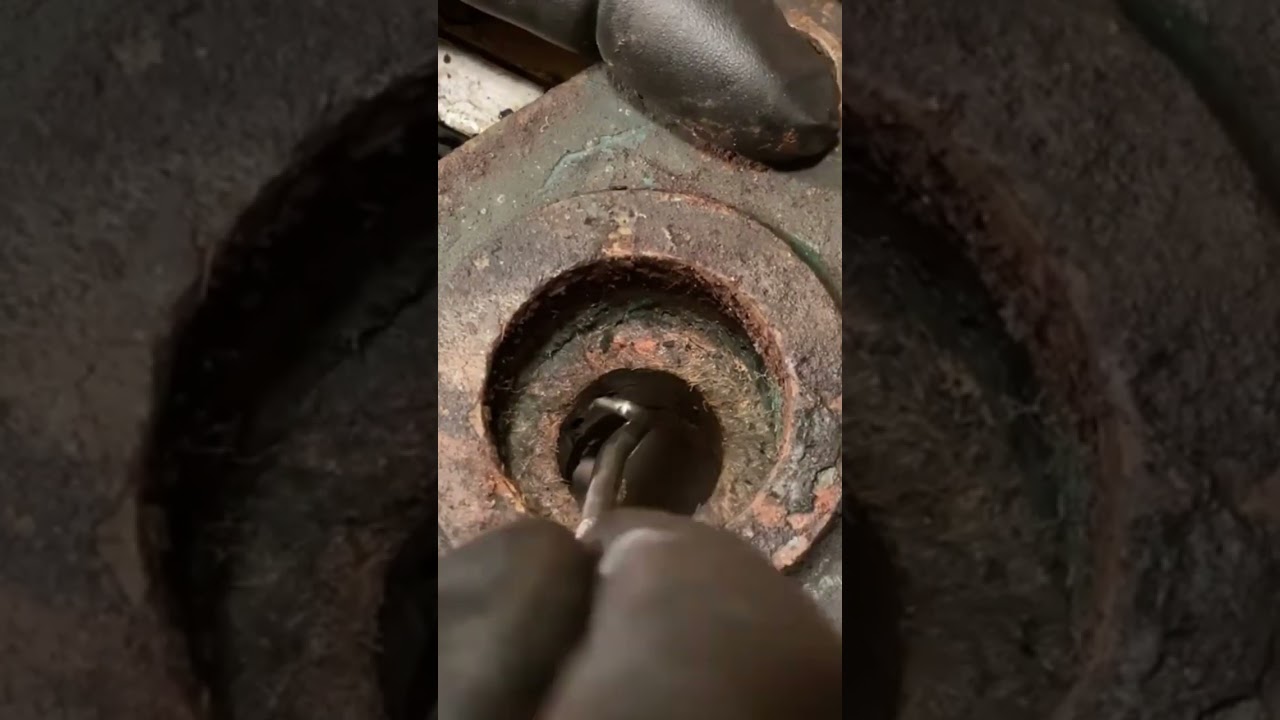 Removing old gaskets during restoration of an old water pump.