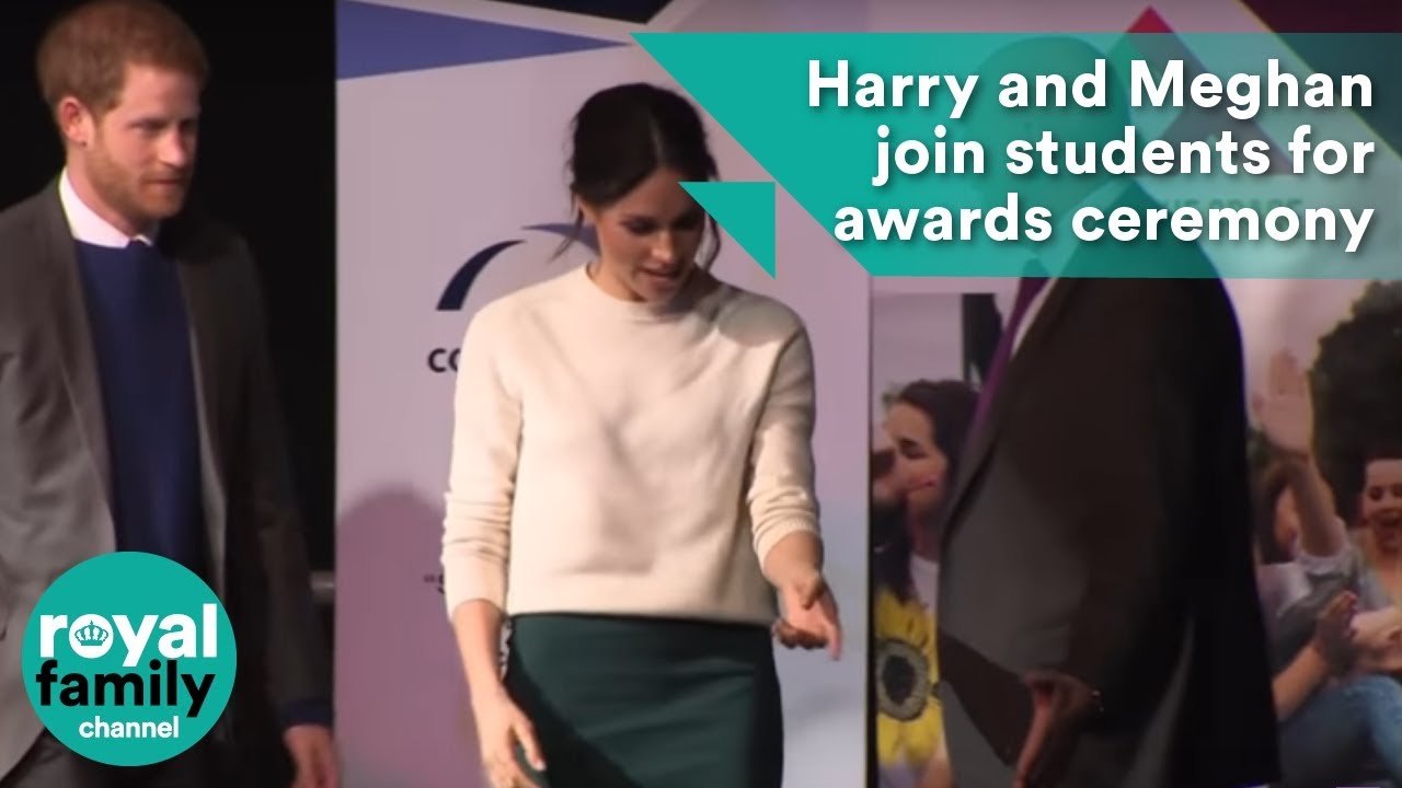 Prince Harry and Meghan Markle join students on stage as they receive award