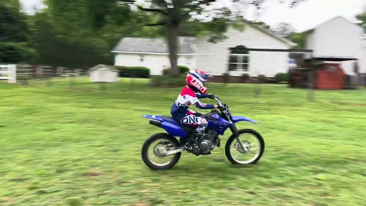 Kids out riding the dirt bikes, four wheeler, and Jace on the TTR125