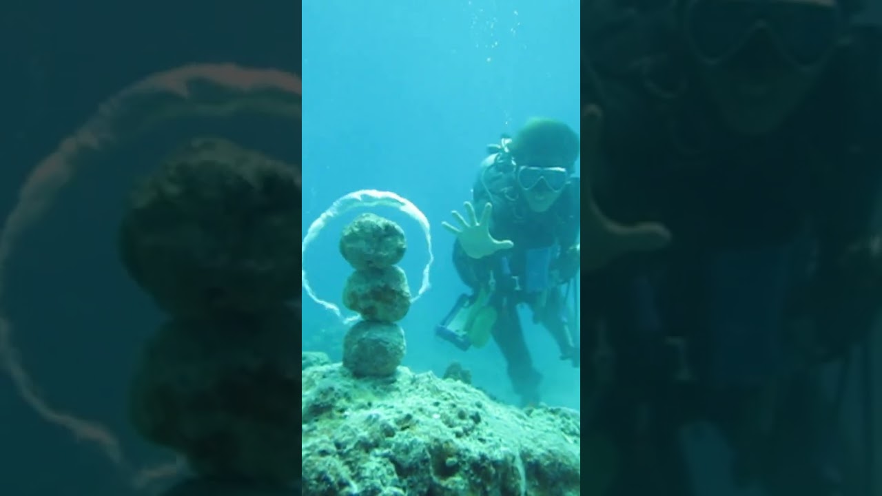 Diver Knocks Down Stack of Rocks With Bubble Ring