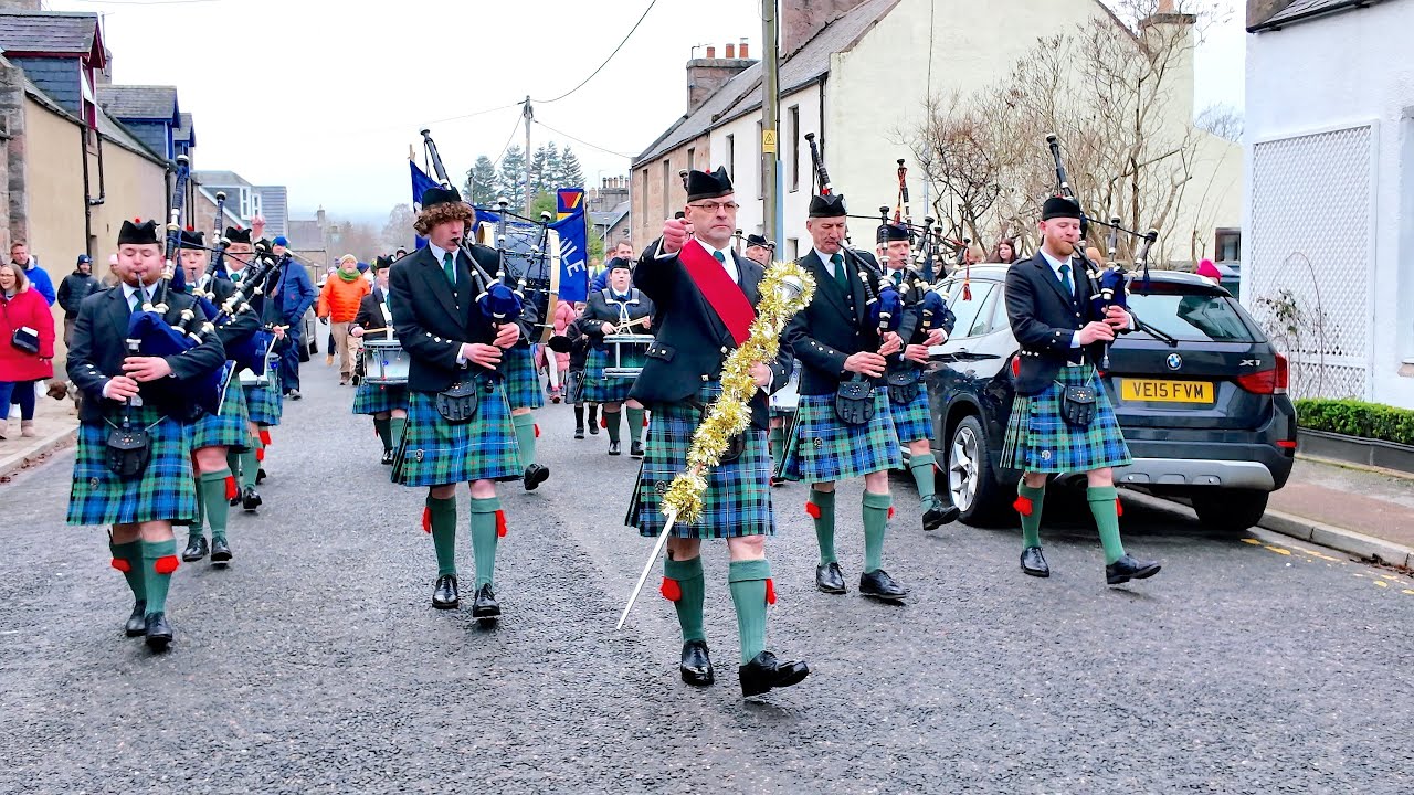 Flett from Flotta as Ballater Pipe Band lead 2025 Little Masons Christmas Parade through Ballater