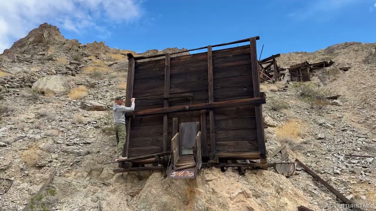 Operating the Gate on an Old Gold Mine Ore Bin in Death Valley