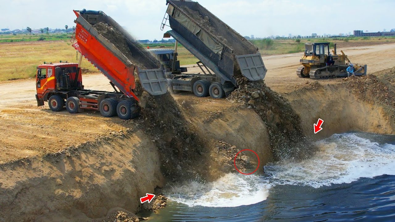 Be careful, the bulldozers incredible skills to push rocks into the deep lake with a rock dump truck
