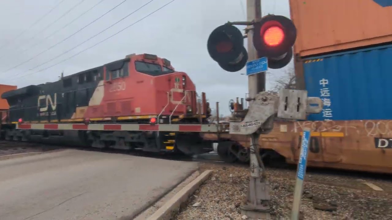 Southbound CN Intermodal with special box car and DPU on the Leightion sub at West chicago 