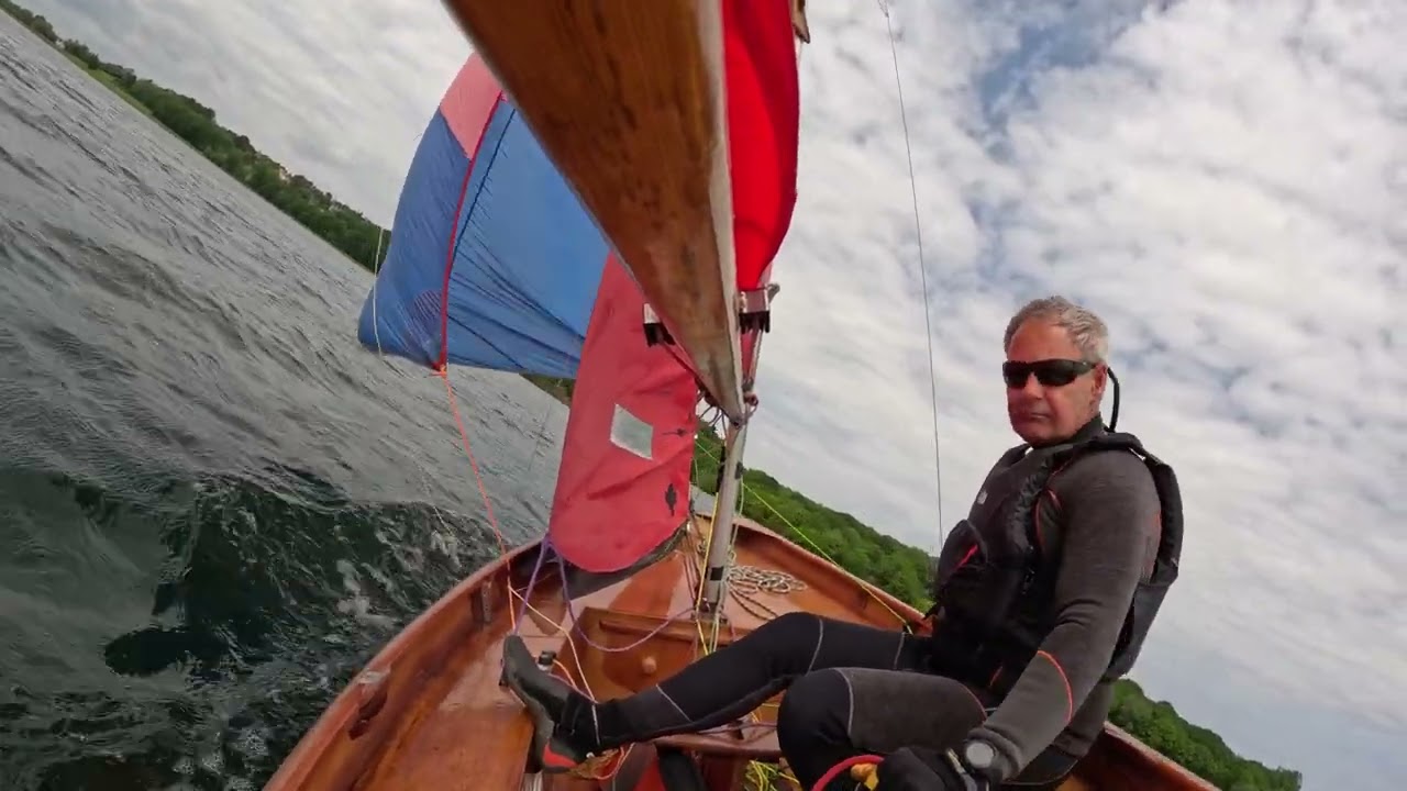 Mirror dinghy sailing with the spinnaker up.