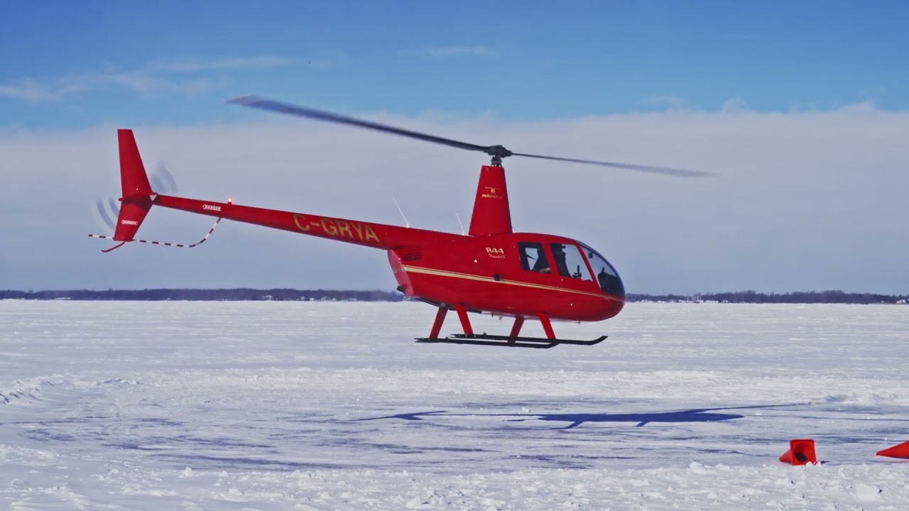 Helicopter take off from frozen river.
