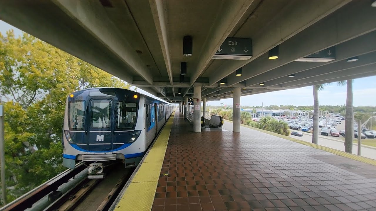 Miami Metrorail Southbound Orange Line train arriving and departing at Dadeland North Station. 