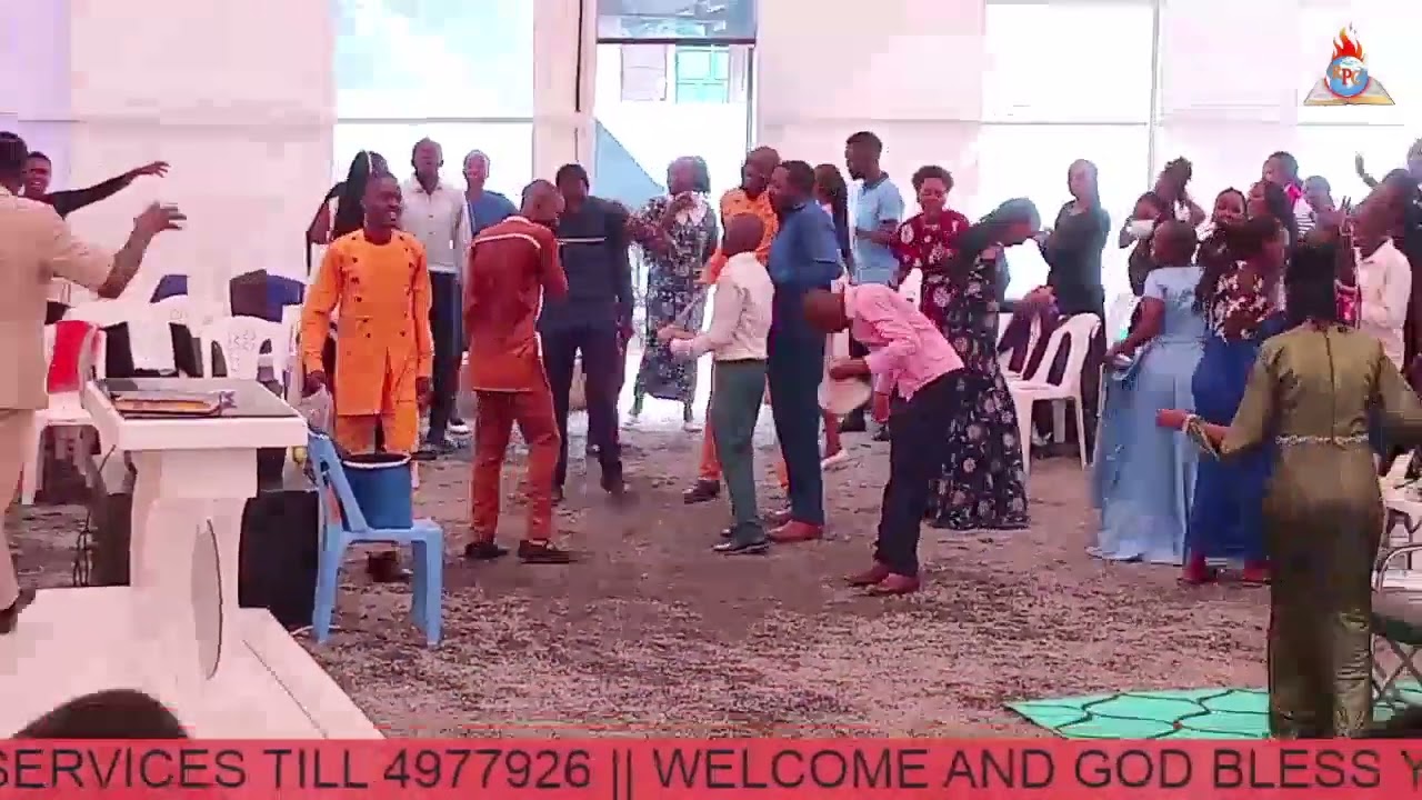 Apostle Michael Muthomi leading in praise powerfully at Revival Pillars church Nairobi 