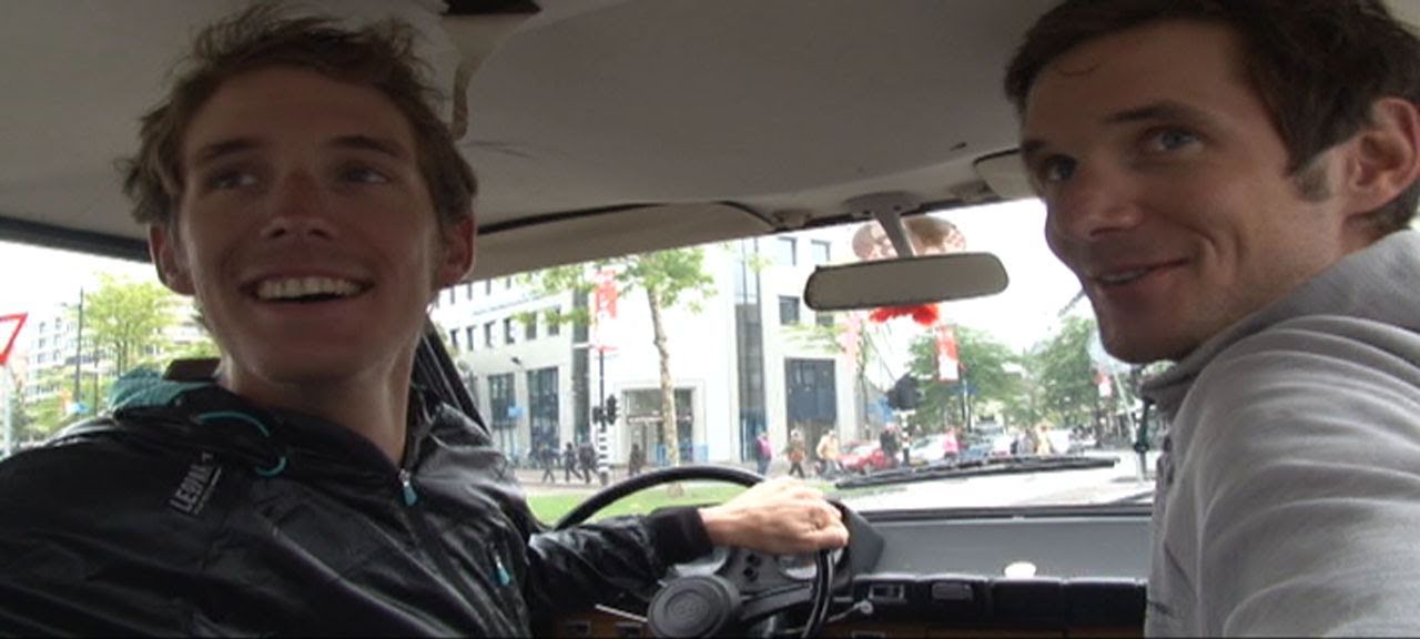 Andy and Frank Schleck racing in car through Eindhoven