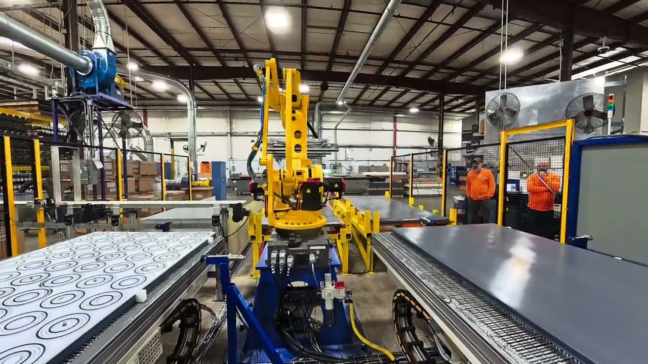 Robotic machine tending of a dual pallet CNC router with a Fanuc M410i/185 robot loading 4x10 sheets