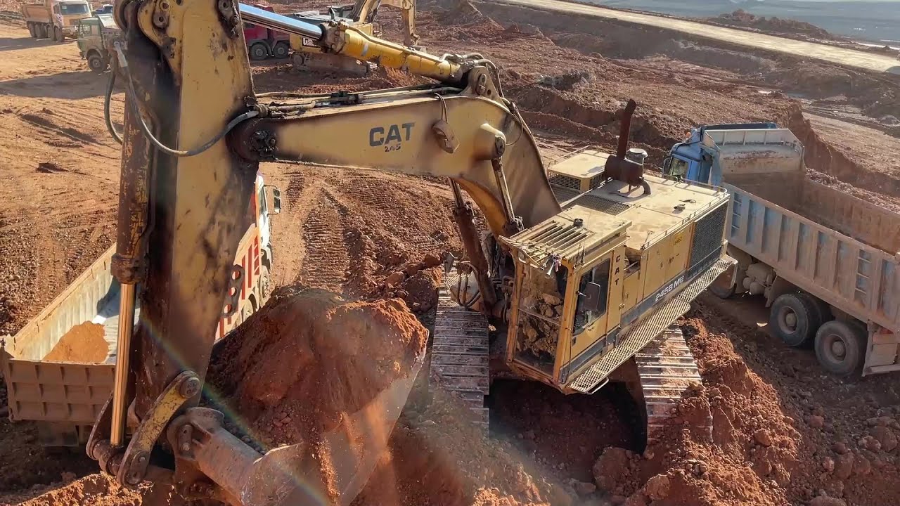 Caterpillar 245B Excavator Loading Mercedes And MAN Trucks