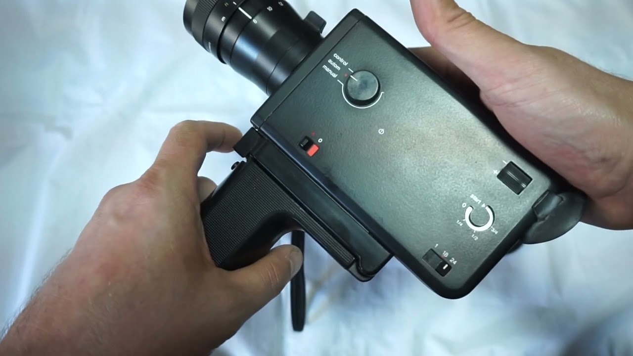 Braun Nizo S 125 loading Super 8 film and batteries on Super 8 camera Braun Nizo S125 super 8 camera