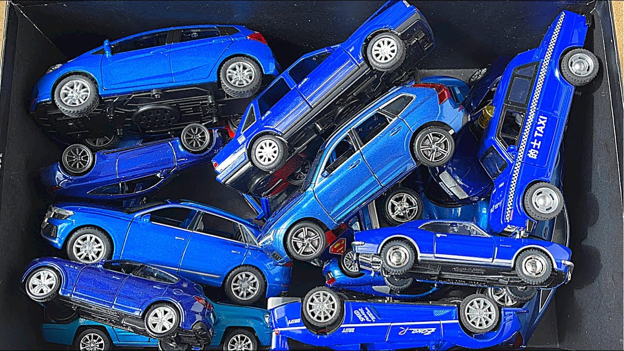 Various Blue Diecast Model Cars From A Black Box