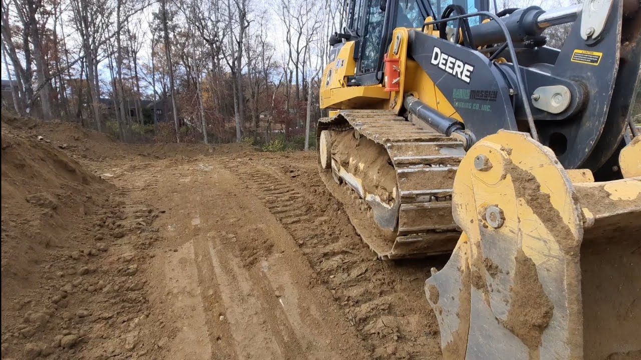 filling in a silt pond with john deere track loader