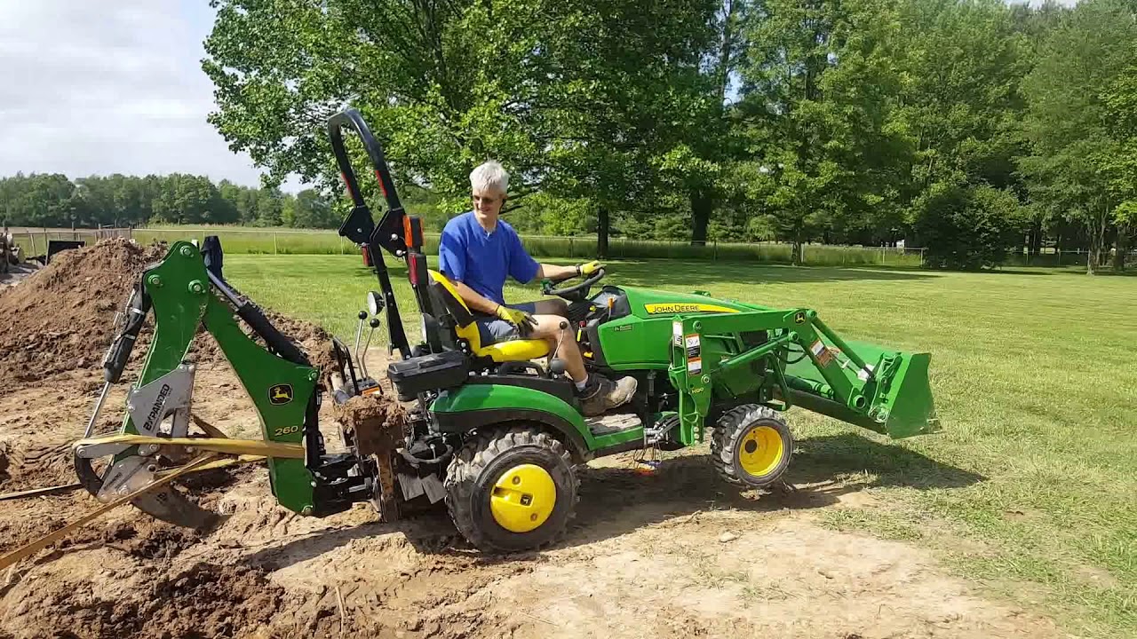 John Deere 1025R & Bxpanded ripper take on monster stump