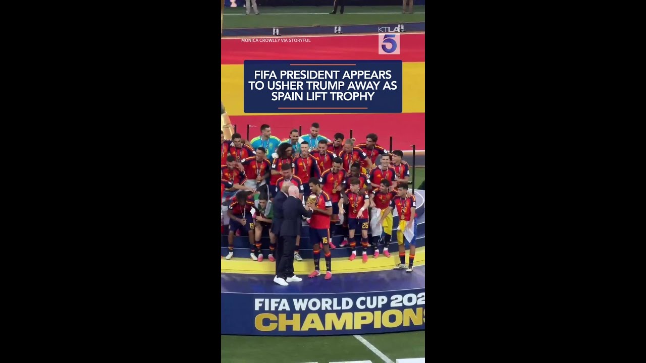 FIFA president appears to usher Trump away as Spain lift trophy