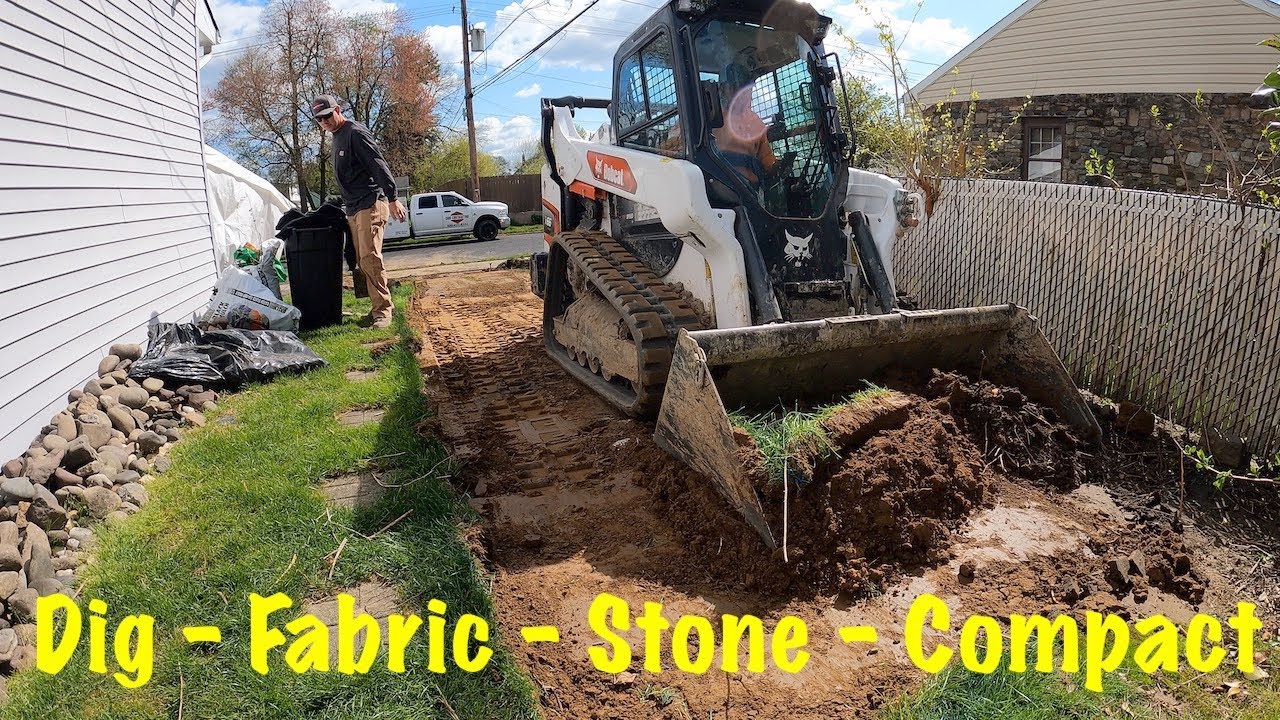 Stone driveway with skid steer