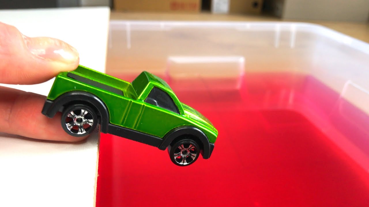 Various diecast cars moving and falling into the water