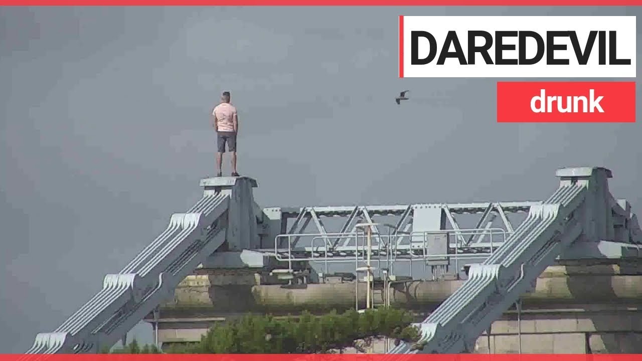 Drunk man scales 150ft bridge to escape police | SWNS TV