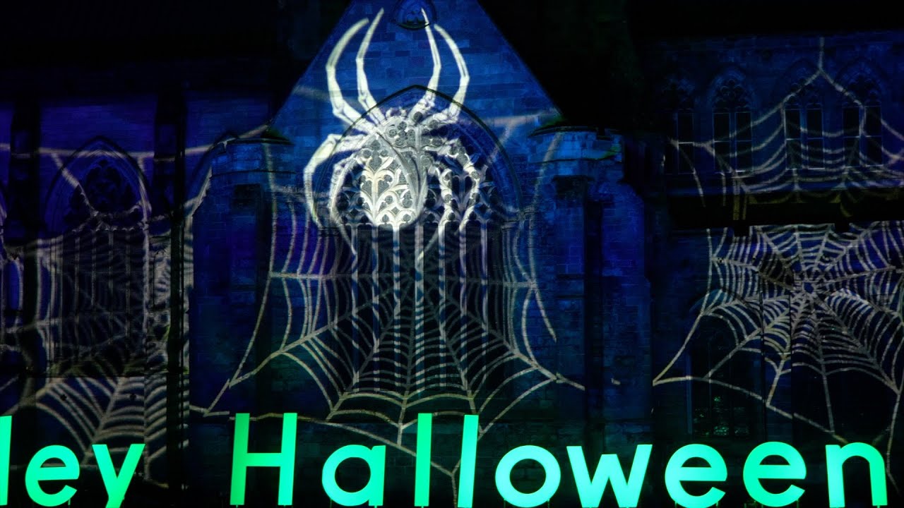 2024 Paisley Halloween Festival and costume Parade past illuminated Paisley Abbey in Scotland