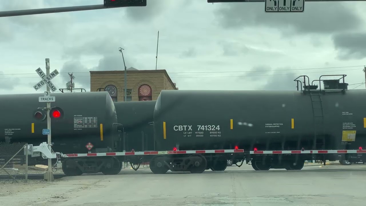 Couple of trains passing at railroad crossing