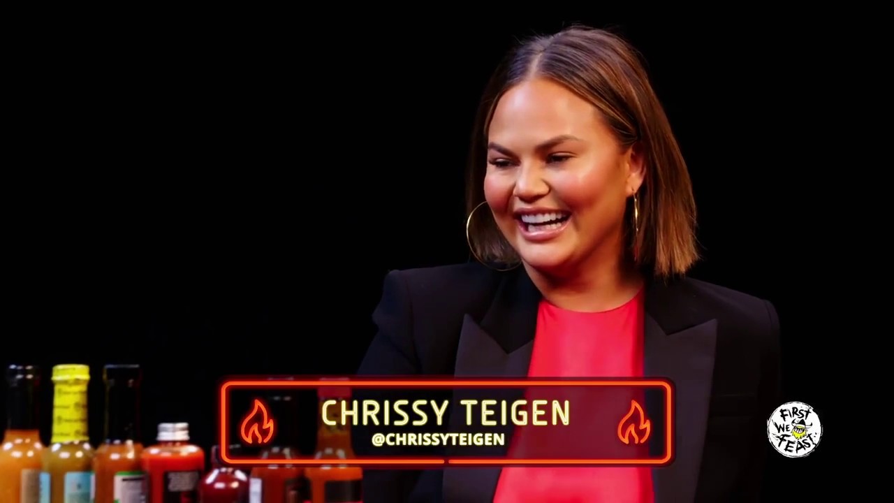 Chrissy Teigen licks some Hot Ones