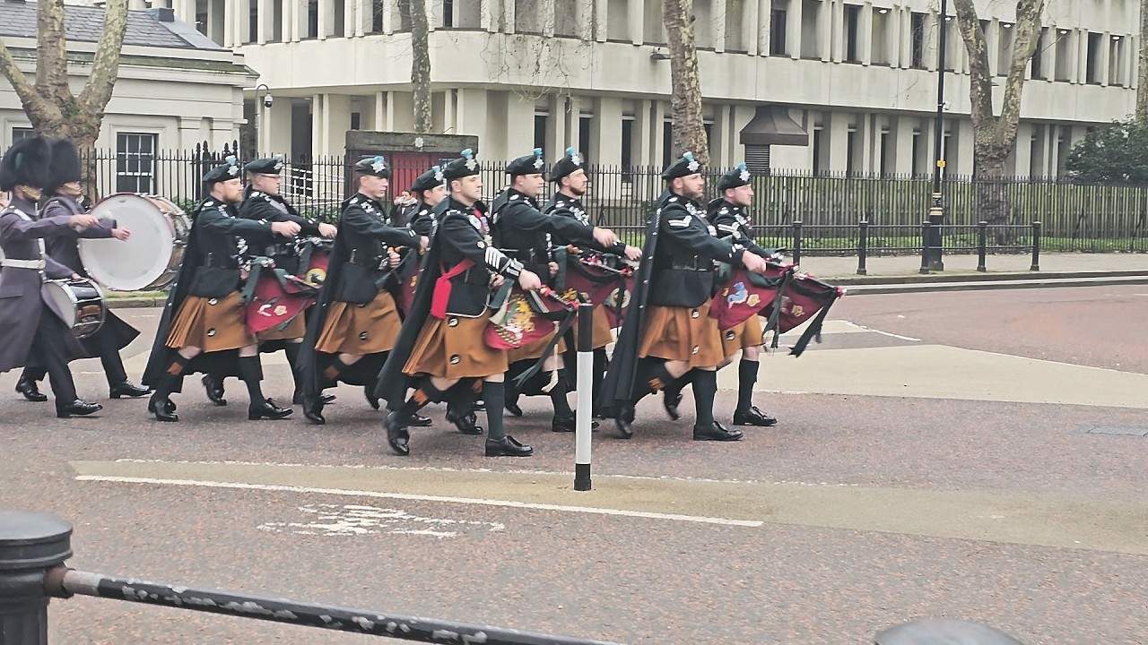 9 Men Wearing Kilts March To The Palace