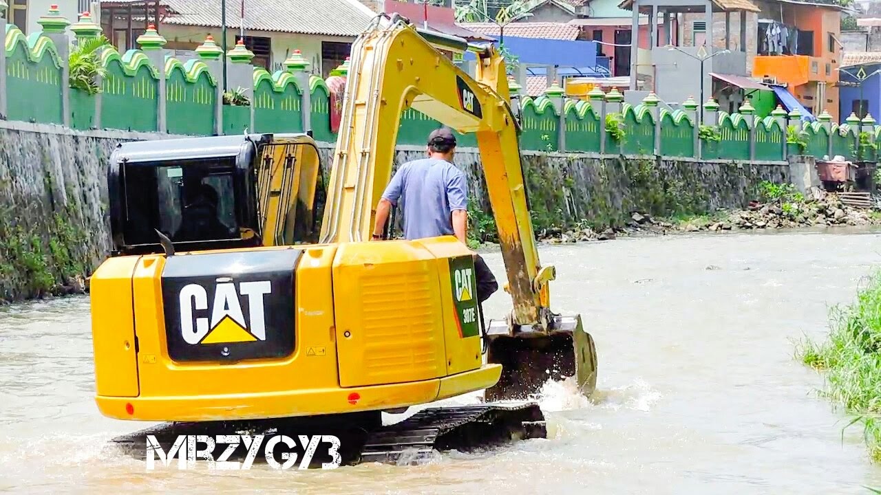 Mini Excavator CAT 307E Working On The River