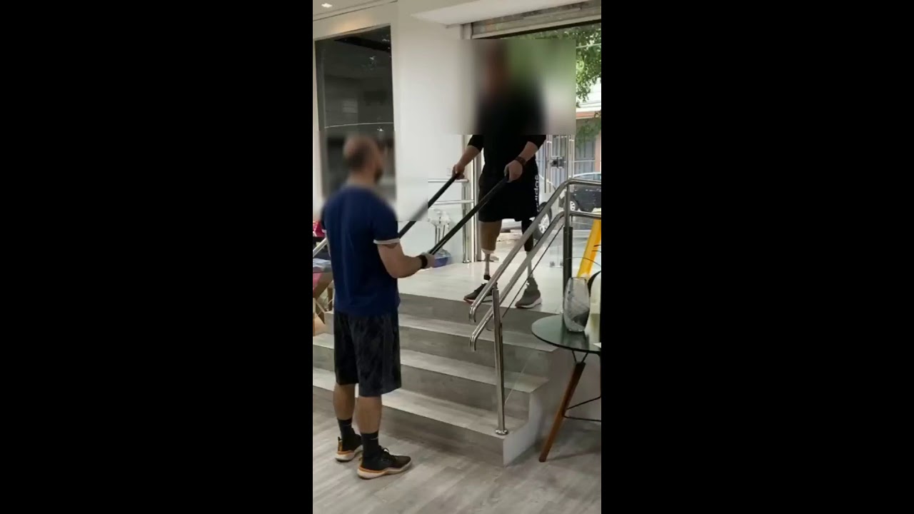 Stylish Hip Amputee Climbing Down Staircase | A Friend Helping the Amputee man to get down stairs
